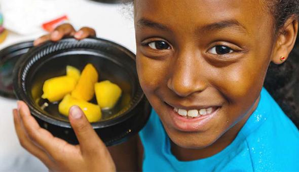 Girl with bowl of fruit