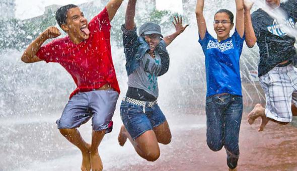 Kids jumping in a fountain