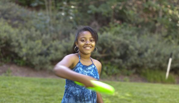 Girl playing outside with frisbee