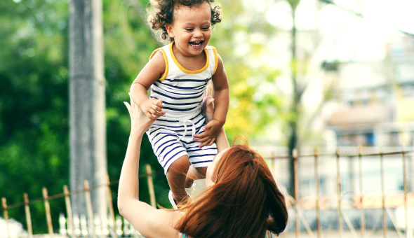 Mom lifting child above head