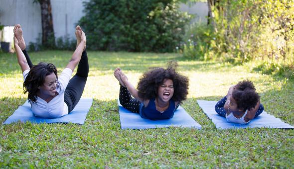 Family does yoga outside