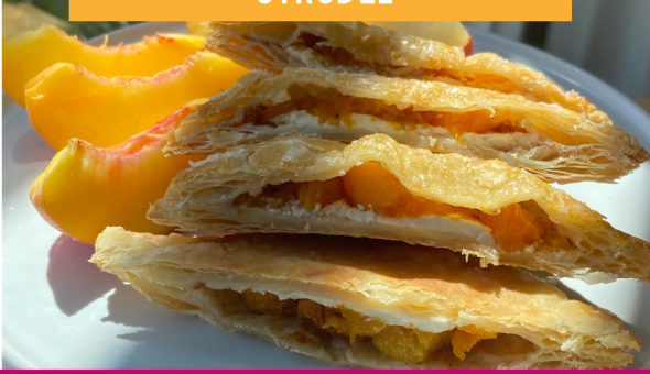 Peach pie strudels cut with the filling and flaky crust on a plate with fresh peach slices