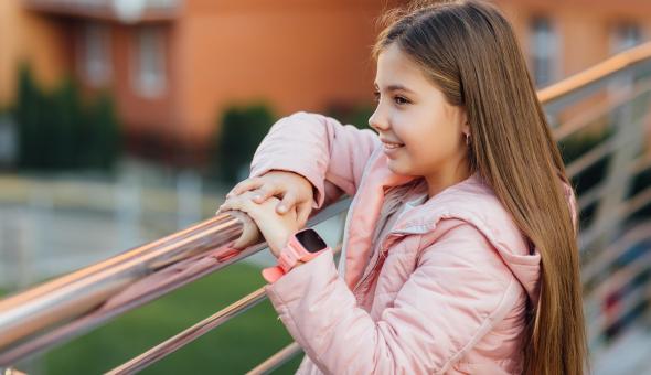 Girl wearing smartwatch outside