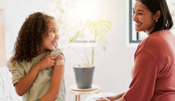 Parent sits with child after vaccination
