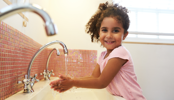 Girl washes hands