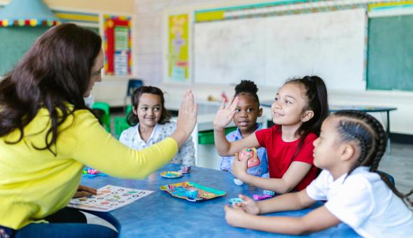 A teacher connects with her students during a classroom activity.